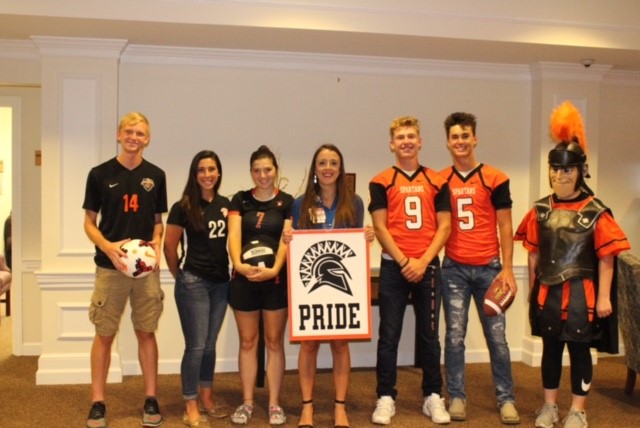 people wearing jerseys and holding sign